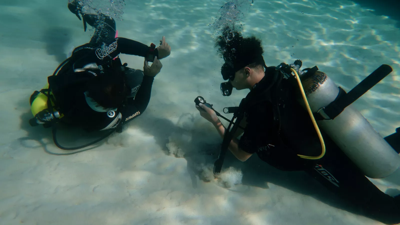 Scuba instructor teaching beginners Scuba Diver first experience at Playa Coral Varadero, Cuba