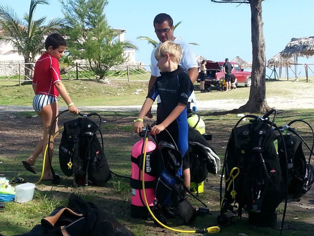 Scuba diving equipment explained to a beginner before a first dive in Cuba