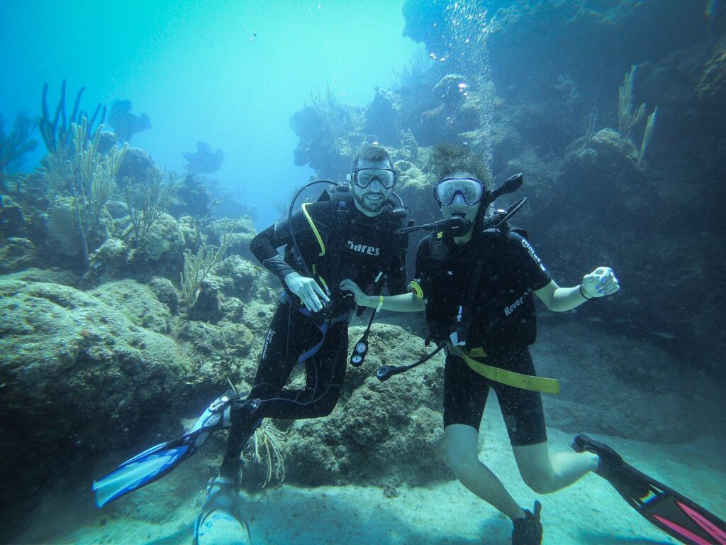 Divers Couple exploring the coral reef near Bacunayagua Cuba