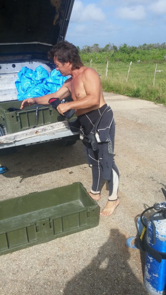 Scuba diving equipment being loaded into a private transfer vehicle in Cuba