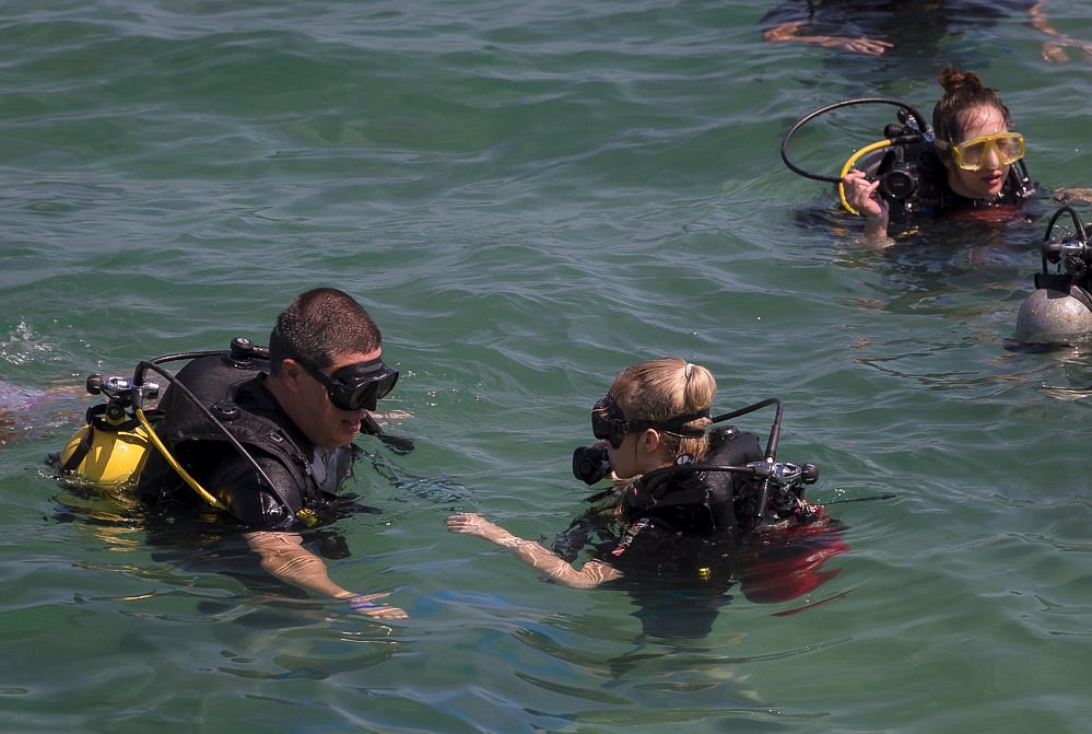 Beginner scuba diver practicing in shallow water with an instructor in Cuba